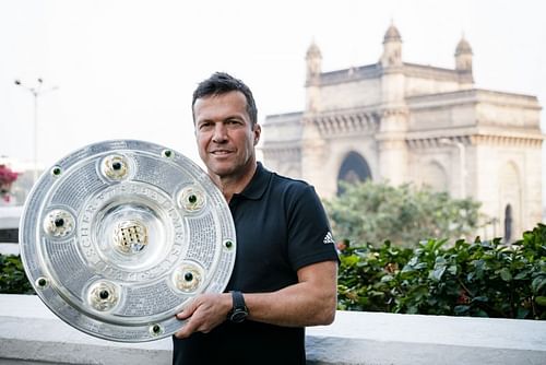 Lothar MatthÃ¤us with the Bundesliga title in Mumbai on Wednesday. (Image: ISL Media)