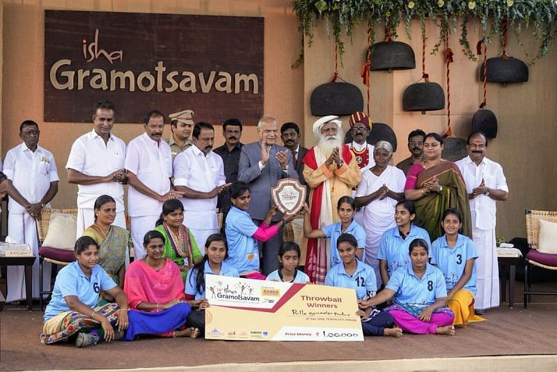 Winning Throwball team with their trophy and prize money.