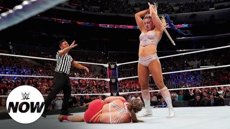 Charlotte Flair viciously assaults Ronda Rousey with the kendo stick at Survivor Series (2018).