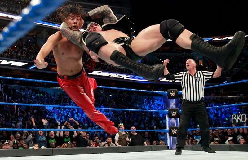 The Apex Predator Randy Orton hits Shinsuke Nakamura with an RKO.