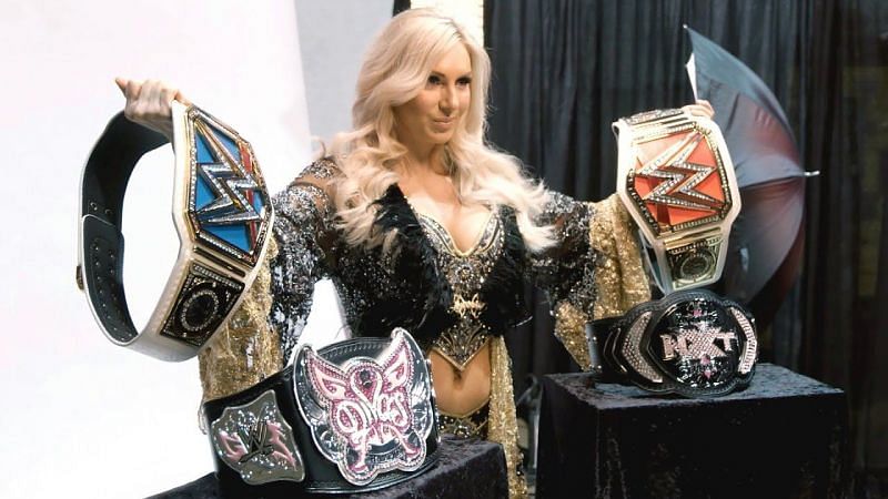 Charlotte posing with all the belts