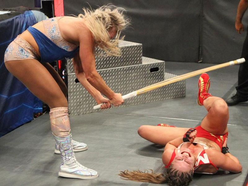 Charlotte assaulting Ronda with a kendo stick at Survivor Series