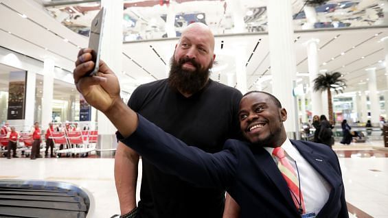 The Big Show poses for a photo with a fan, whilst between flights.
