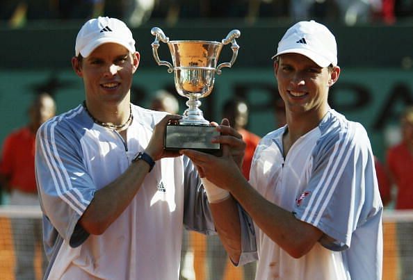 Bob Bryan and Mike Bryan holding aloft their first Grand Slam trophy at the French Open of 2003
