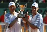 Bob Bryan and Mike Bryan holding aloft their first Grand Slam trophy at the French Open of 2003