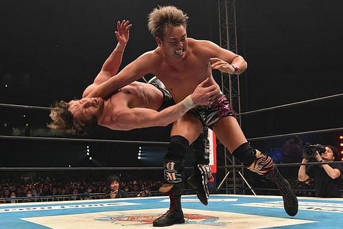 The Rainmaker Kazuchiko Okada delivers the Rainmaker clothesline to Kenny Omega