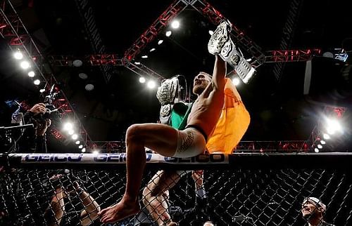 Conor McGregor becomes the first dual champion in UFC history at UFC 205