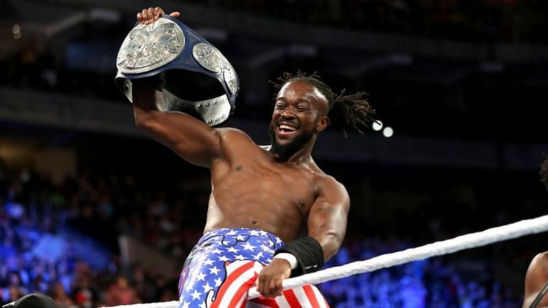 Kofi Kingston is shown holding one of the Smackdown Tag Team Championship belts. (Source - WWE)