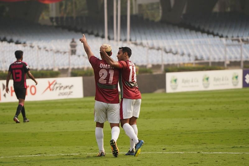 Omar celebrates with Abhishek Ambekar after scoring the goal