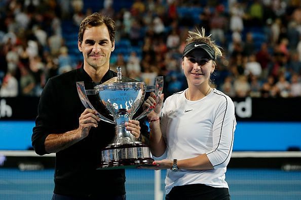 Federer and Bencic pose with the trophy after winning the Hopman Cup for Switzerland
