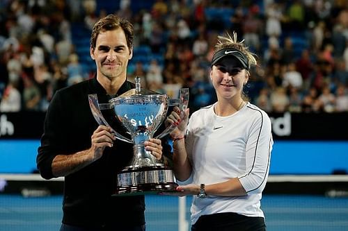 Federer and Bencic pose with the trophy after winning the Hopman Cup for Switzerland