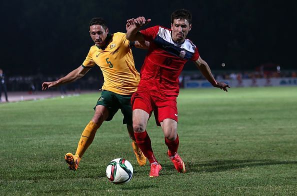 Mirlan Murzaev in action for Kyrgyzstan in red jersey v Australia - 2018 FIFA World Cup Qualifier