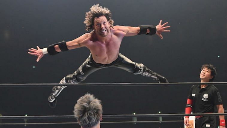 Kenny Omega sails over the ropes during a dive