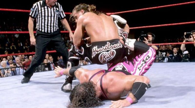 Bret Hart, trapped in his own finishing move the Sharpshooter, never tapped out but the bell rang anyway