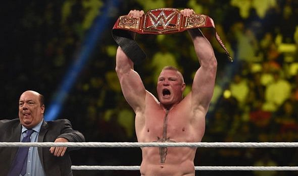 Brock Lesnar, flanked by advocate Paul Heyman, hefts the WWE Universal title over his head