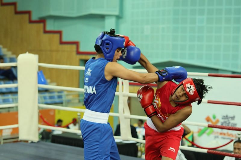 Shashi Chopra(Red) in action against Sakshi Choudhary ( Blue) during U-21 feather-weight section (57kg) at Khelo India Youth Games