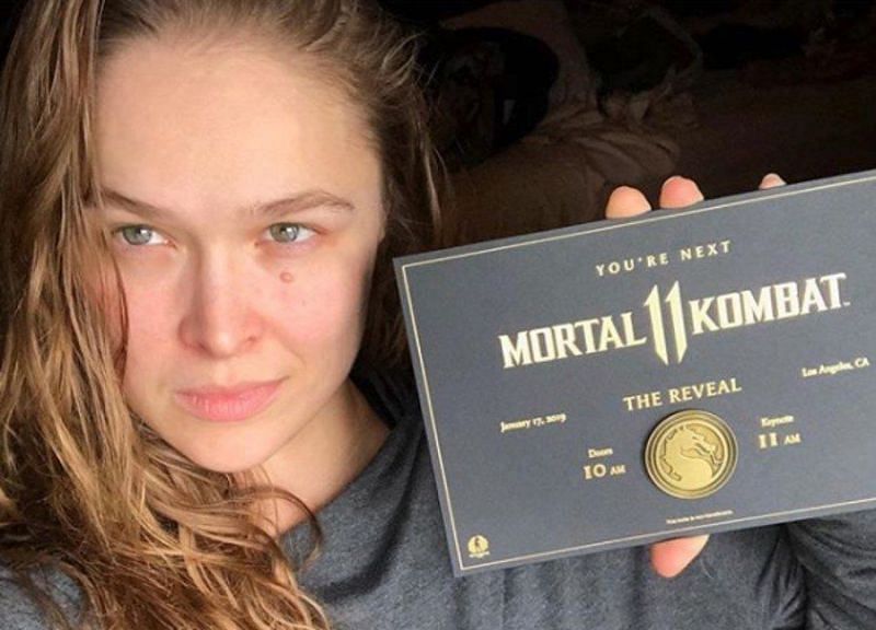 Ronda Rousey shows off her invite to the MK 11 reveal event.