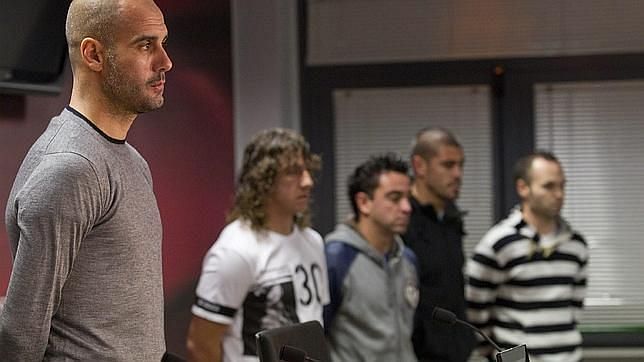 Guardiola with his players including Puyol and Xavi