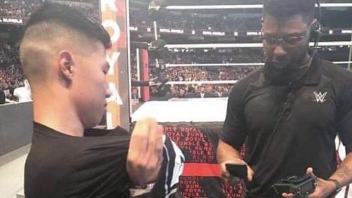 A fan at ringside at the Royal Rumble was forced to remove his AEW shirt.