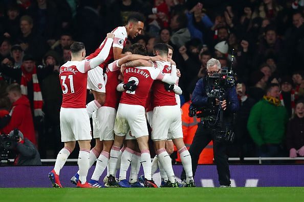 Arsenal players celebrate after scoring against Chelsea FC in the Premier League