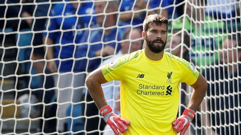 Alisson reacts after conceding a goal