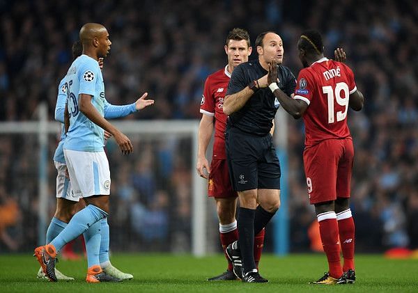 Mane gets booked by the referee in a Champions League match against Manchester City