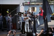 Ron Dennis and Mika Hakkinen hug in the paddock after the Suzuka win