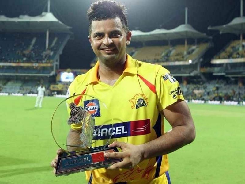 Suresh Raina poses with a trophy