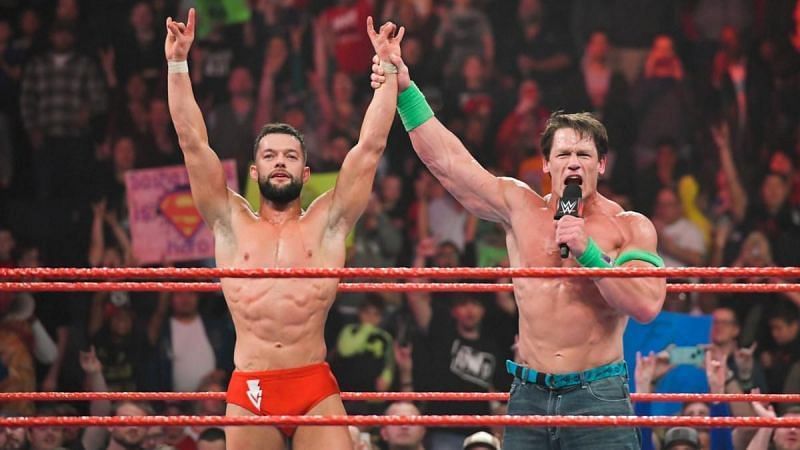 John Cena raises Finn Balor's hand in victory on RAW.