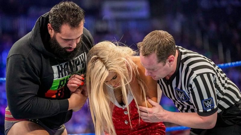 A concerned Rusev cares for his wife after an attack by Shinsuke Nakamura.
