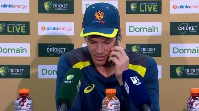 Image result for tim paine picks up a phone call at press conference