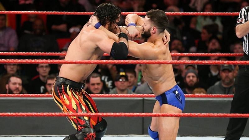 Rollins &amp; Balor competing in a match on Raw.
