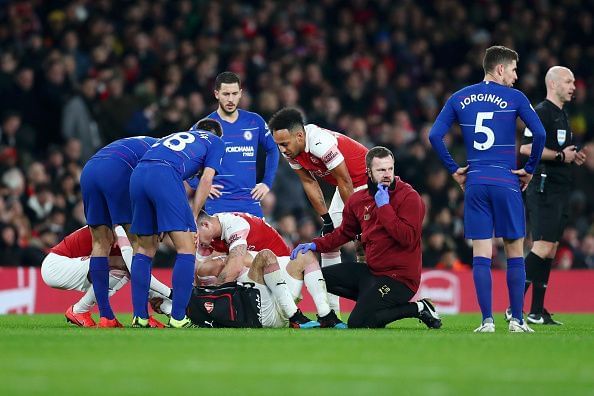 Bellerin being consoled by teammates and rivals alike as the Spaniard cried uncontrollably on the turf