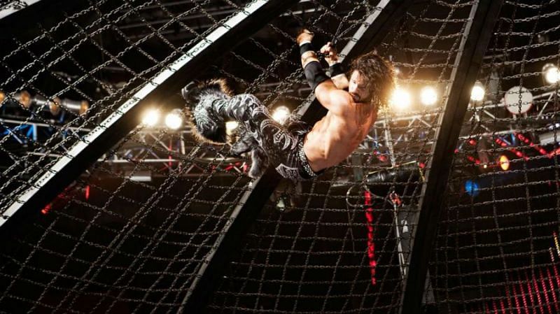 John Morrison climbing the domed lid of the Elimination Chamber