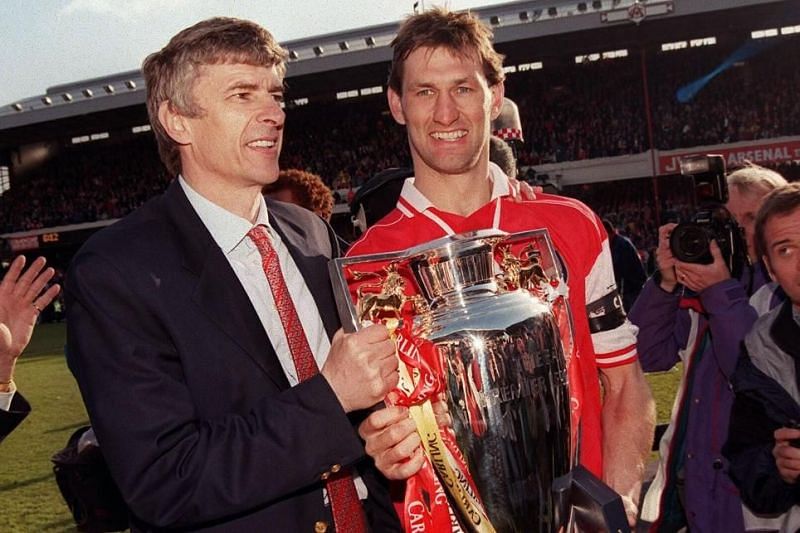 Captain Tony Adams and Arsene Wenger celebrate the title together