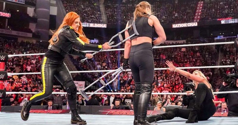 Becky viciously attacked Ronda and Charlotte with her crutches