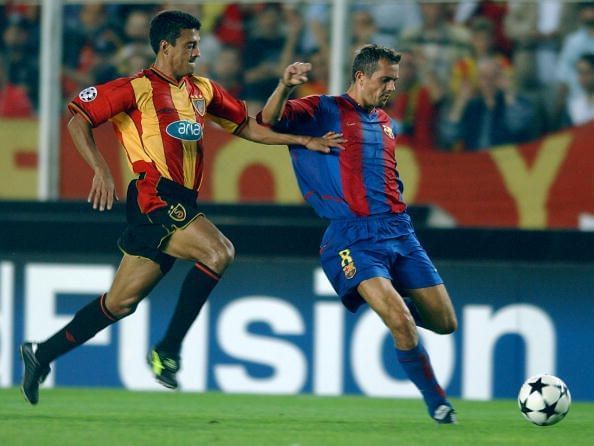 Phillip Cocu of Barcelona is challenged by Trevino Sergio Almaguer of Galatasaray