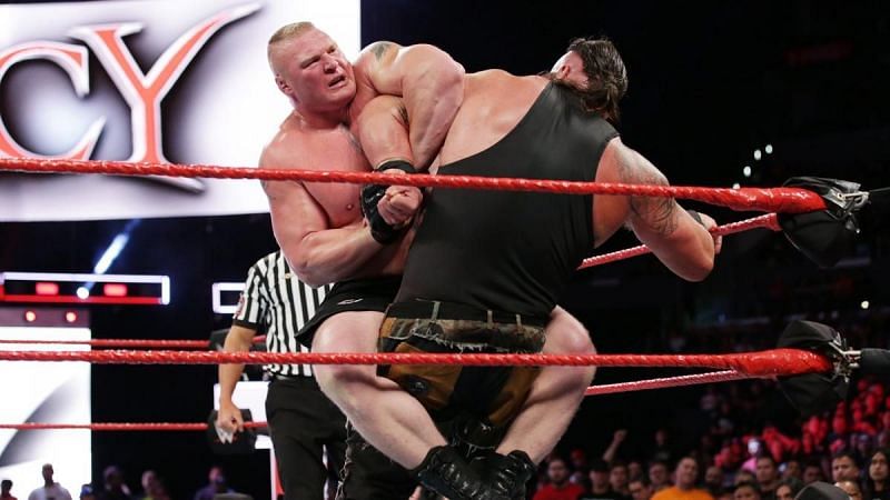 Lesnar briefly traps Strowman in the Kimura Lock.