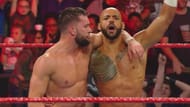 Finn Bálor and Ricochet celebrating after their win