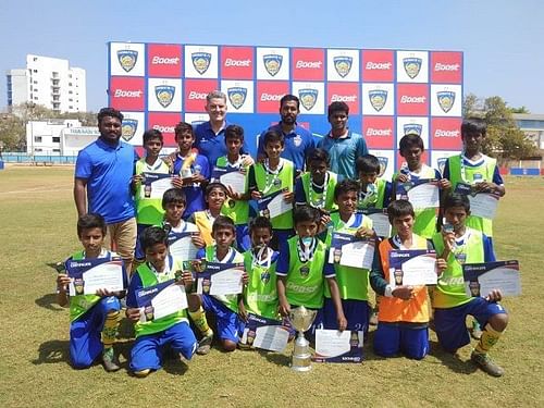 Players of Anjuman Matriculation with Chennaiyin FC coach John Gregory and player Dhanpal Ganesh after winning the Boost Chennaiyin FC Football Championship (U-13)