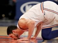 Enis Kanter kissing the Knicks floor after checking-in against Dallas Mavericks J.R. Smith of the Cleveland Cavaliers