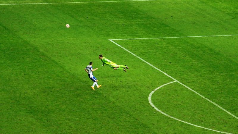  Manuel Neuer flying to head the ball away from danger in a counter-attack.