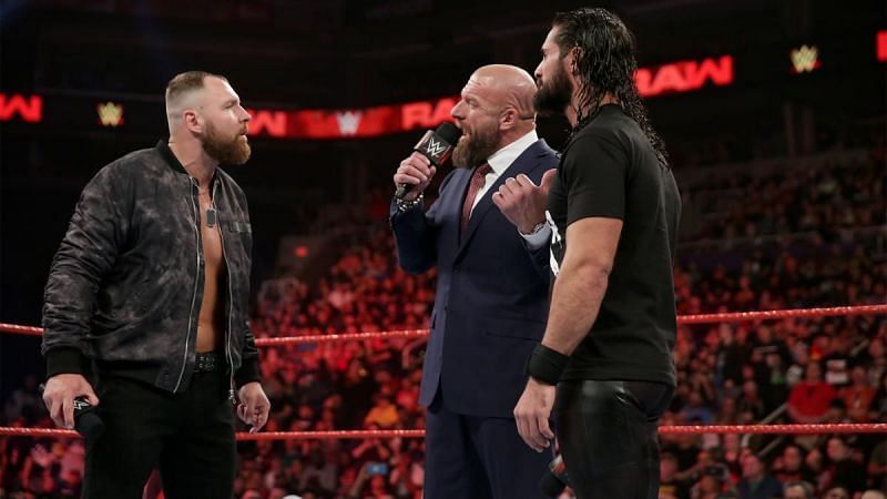 Dean Ambrose in the ring with Triple H and Seth Rollins.