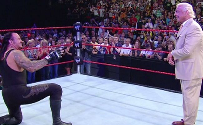 Undertaker bowing down to Ric