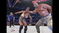 Chavo Guerrero prepares to slam Miss Jacqueline into the turnbuckle.