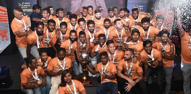 Chennai City players celebrate with the I-League trophy