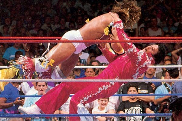 The Ultimate Warrior takes down Honky Tonk Man with a flying tackle