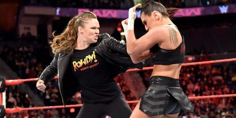 Rousey takes down Deville in an in-ring segment