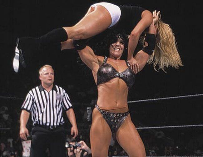 Chyna hefts Trish Stratus into a gorilla press slam.