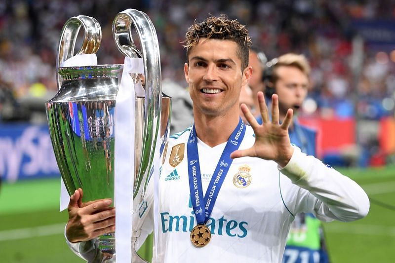 Ronaldo posing with his fifth overall and third consecutive UEFA Champions League Trophy